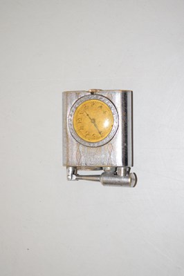 Lot 131 - A vintage cigarette lighter with in built clock