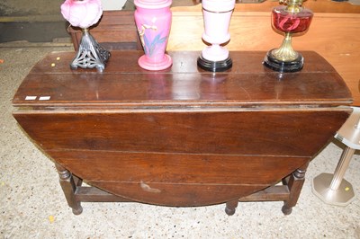 Lot 324 - A Georgian oak drop leaf dining table