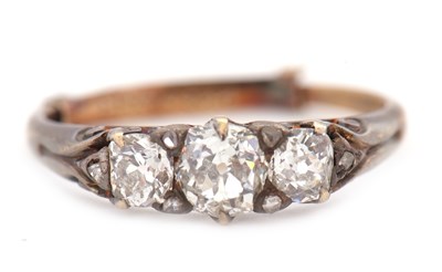 Lot 76 - A three stone diamond ring, the three old mine...