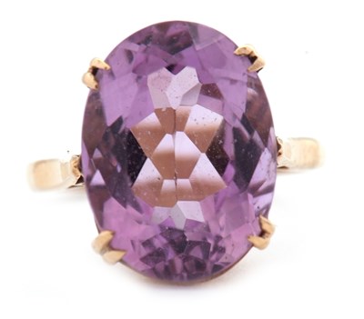 Lot 70 - An amethyst ring, the oval mixed cut amethyst...