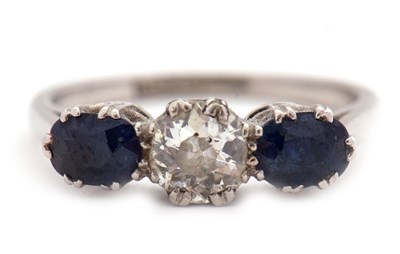 Lot 4 - A three stone sapphire and diamond ring, the...