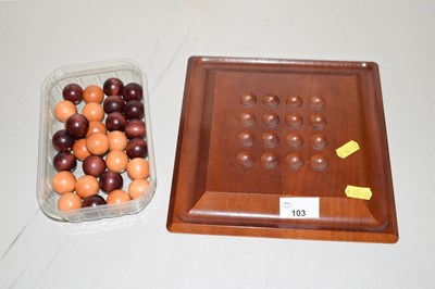 Lot 103 - A wooden Solitaire board with balls