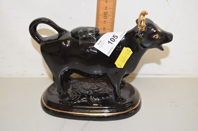 Lot 105 - A black and gilt cow creamer