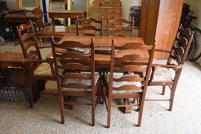 Lot 311 - An oak drawer leaf dining table and six chairs