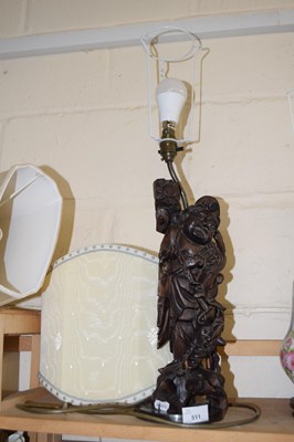 Lot 511 - A hardwood Chinese table lamp with figural base