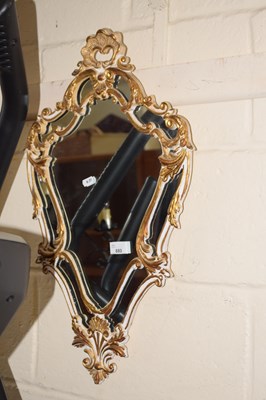 Lot 880 - A gilt shielded wall mirror