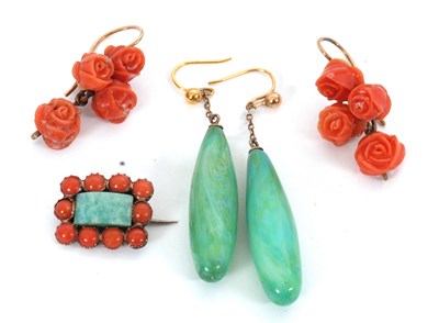 Lot 238 - A pair of carved coral earrings, each set with...