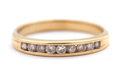 Lot 64 - A diamond ring, quarter set with round...
