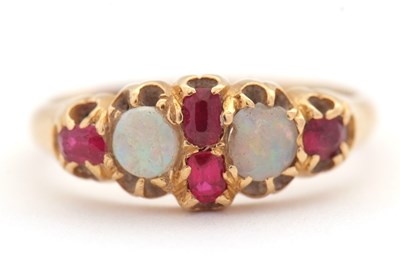 Lot 21 - An opal and ruby ring, wtih two round opal...