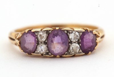 Lot 12 - An amethyst and diamond ring, set with three...