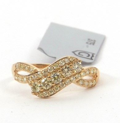 Lot 157 - A 9ct yellow diamond ring, the crossover style...