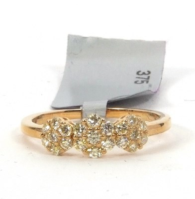 Lot 152 - A 9ct yellow diamond ring, the three clusters...