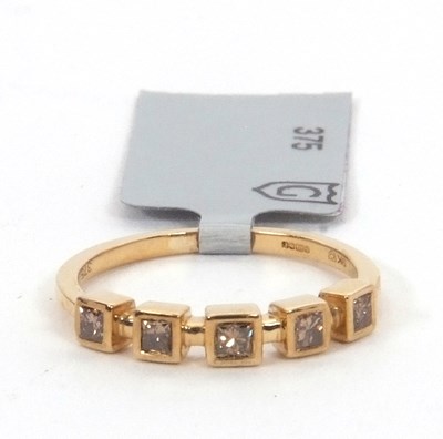 Lot 178 - A 9ct champagne diamond ring, set with five...