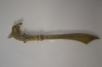 Lot 303 - A brass letter opener, the handle shaped as an...