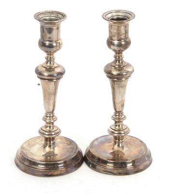Lot 64 - A pair of George V silver candlesticks having...