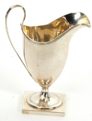 Lot 83 - A George III silver helmet cream jug raised...