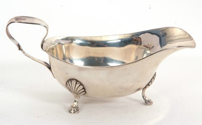 Lot 128 - A George V silver sauce boat of typical form,...