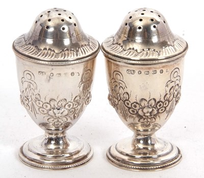 Lot 137 - A pair of Victorian silver peppers of urn form,...