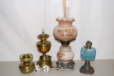Lot 143 - Four various oil lamps, two with electrical...