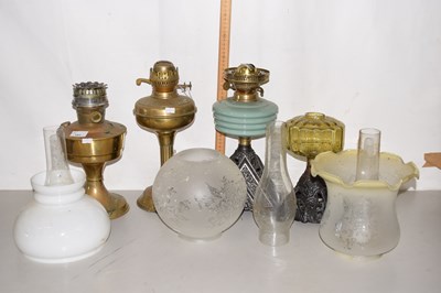 Lot 151 - A group of four various oil lamps with further...
