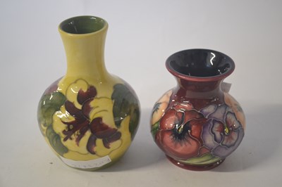 Lot 454 - A small vase, the yellow ground with hibiscus...