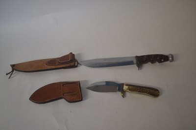 Lot 485 - A replica of a bowie knife in leather scabbard...