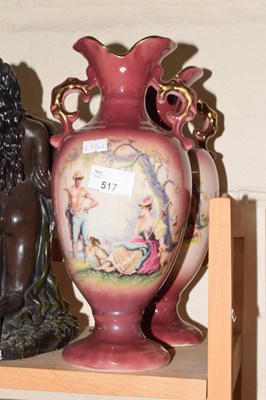 Lot 517 - A pair of pink and gilt decorated vases