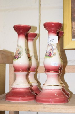 Lot 547 - Four pink decorated candlesticks
