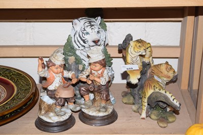 Lot 559 - Figures of tigers and a pair of figures of...