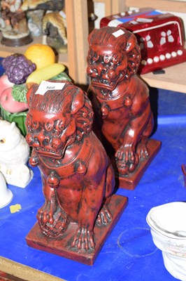 Lot 568 - Pair of red resin dogs of fo