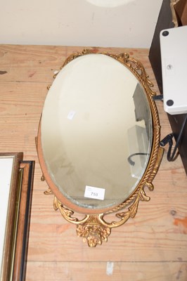 Lot 758 - An oval wall mirror in metal decorated frame