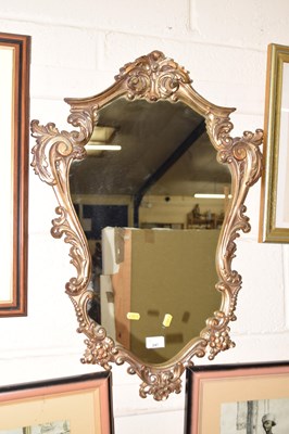 Lot 247 - A shield gilded wooden wall hanging mirror