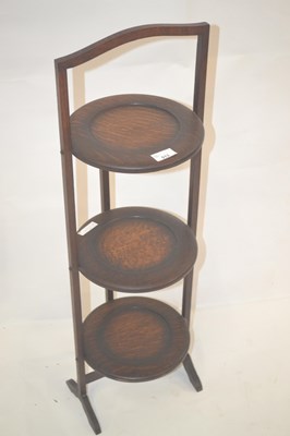 Lot 513 - An early 20th Century oak three tier cake...