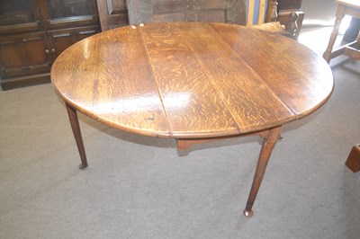 Lot 400 - A George III oak drop leaf dining table raised...