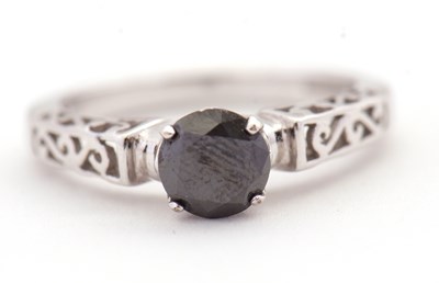 Lot 83 - A 9ct black diamond ring, the round brilliant...
