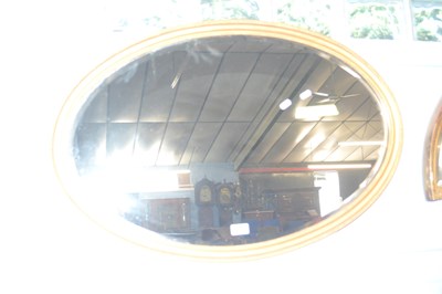 Lot 633 - A 20th Century oval gilt framed wall mirror,...