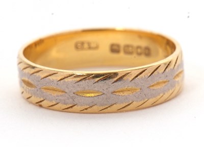 Lot 217 - An 18ct gold ring, 4.5mm wide, with engraved...