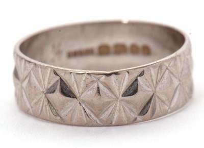 Lot 212 - An 18ct ring, 6mm wide, with impressed...