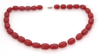 Lot 268 - A 'cherry amber' bead necklace, with slightly...