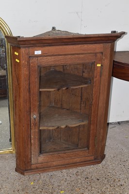 Lot 402 - A Georgian oak corner cabinet with glazed door