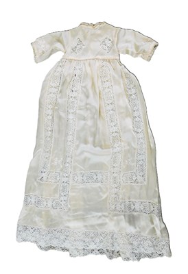 Lot 177 - A cream silk and lace christening gown, with...