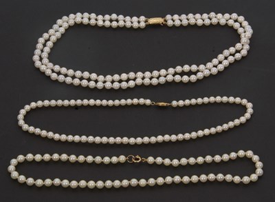 Lot 252 - Three cultured pearl necklaces with gold...