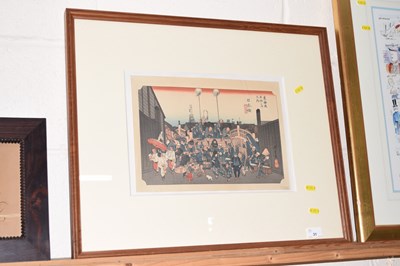 Lot 31 - A framed Japanese wood block study of figures...