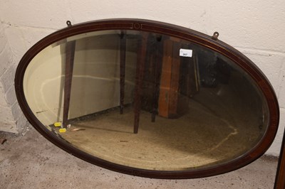 Lot 267 - An Edwardian wall mirror in oval bedded frame