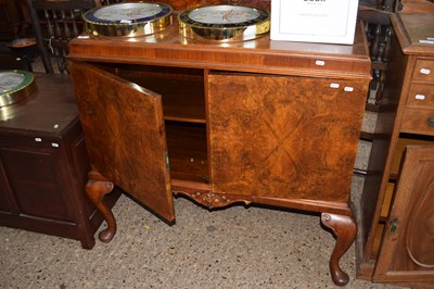 Lot 357 - A walnut veneered two door sideboard on...