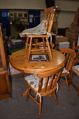 Lot 782 - A round pine kitchen table and four chairs