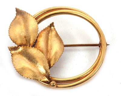 Lot 148 - A gold brooch, the round brooch set with three...