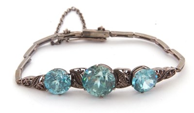 Lot 133 - A blue zircon bracelet, the three round...