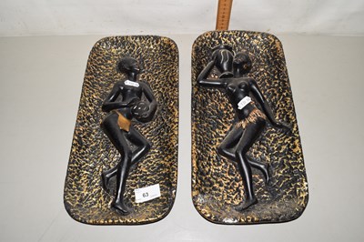 Lot 63 - Two pottery wall plates modelled as African...