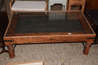 Lot 325 - An Eastern style hardwood glass topped coffee...